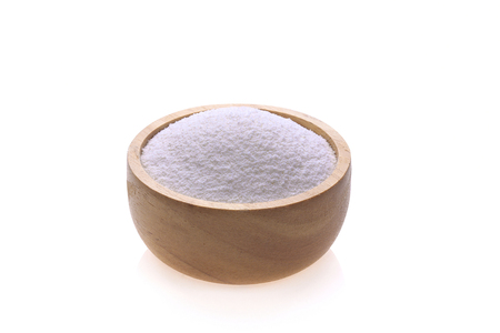 Cream in a separate wooden cup on a white background.の写真素材