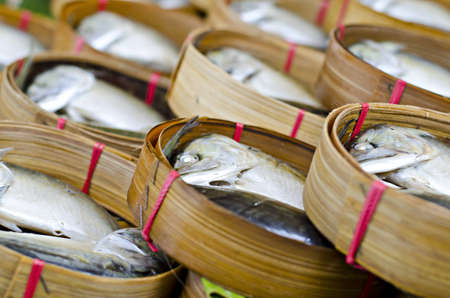 Mackerel fish in bamboo basket at market, Thailandの写真素材