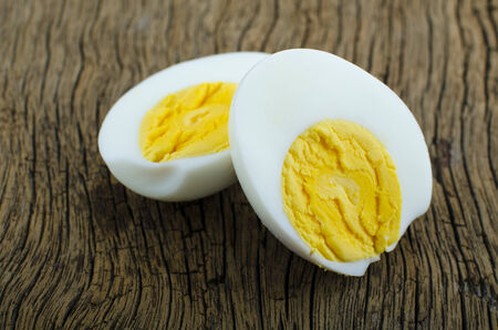 Peeled boiled egg on wooden backgroundの写真素材