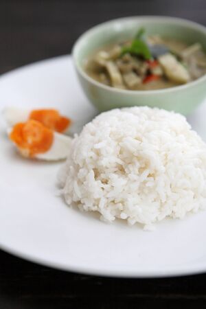 Thai food green curry witn rice in wood backgroundの写真素材