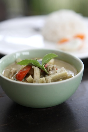 Thai food green curry witn rice in wood backgroundの写真素材