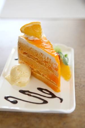 Orange cake on wood backgroundの写真素材