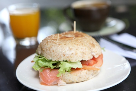 fresh bagel with salmon orange juice and coffeeの写真素材