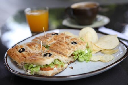 Sandwich with orange and coffee