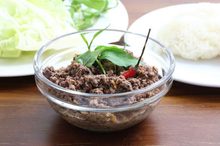 Thai food minced meat with vegetable and chilli on wood backgroundの写真素材
