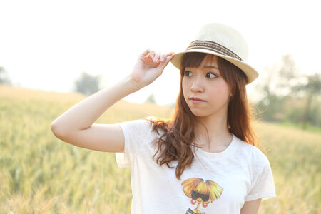 Young smiling woman in field with wheatのeditorial素材