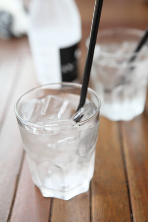 Water in glass in wood backgroundの写真素材