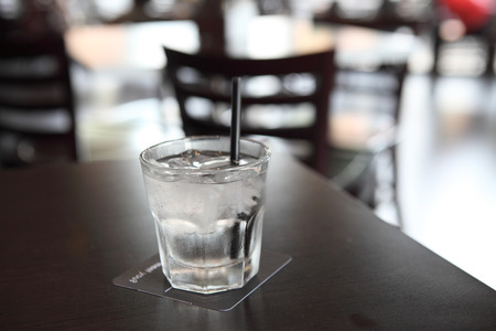 Water in glass in wood backgroundの写真素材