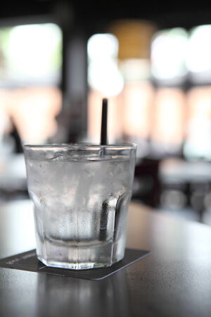 Water in glass in wood backgroundの写真素材