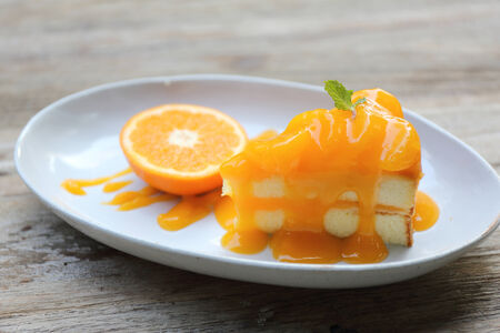 Orange cake on wood backgroundの写真素材