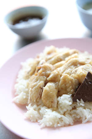 Thai food gourmet steamed chicken with rice , khao mun kai in wood の写真素材