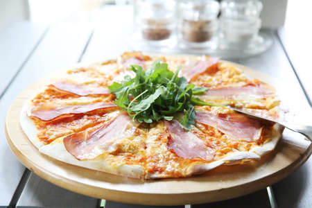 Pizza margherita with parma ham and rocket