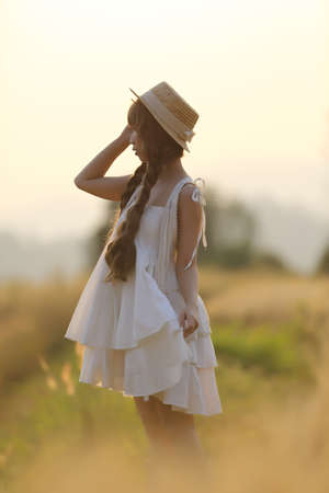 Asian girl on wheat fieldの写真素材