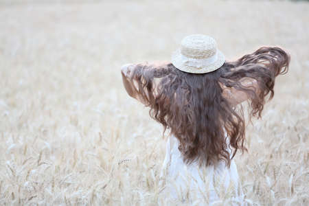 Asian girl on wheat fieldの写真素材