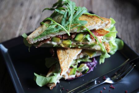 Sandwiches with meet and vegetables on wood backgroundの写真素材