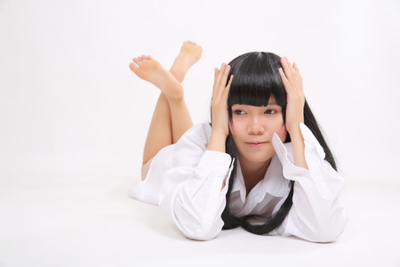 Asian girl with white shirt isolated in white backgroundの写真素材
