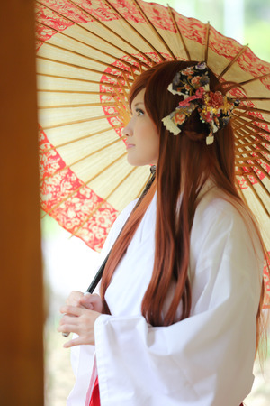 Asian girl portrait, Japanese Miko with umbrellaの写真素材