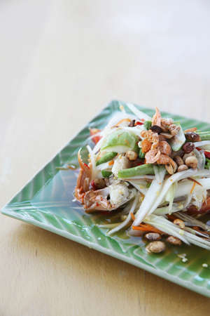Green papaya salad on wood backgroundの写真素材