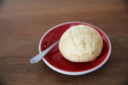 melon pan in coffee on wood backgroundの写真素材