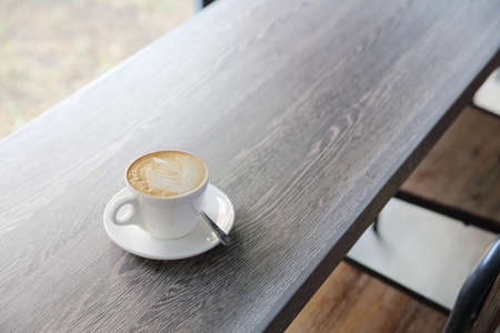 Hot latte coffee on wood background