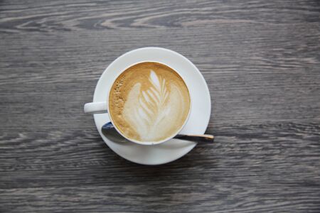 Hot latte coffee on wood background