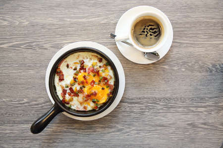 Brealfast fried egg stuff with hot pan with coffeeの写真素材