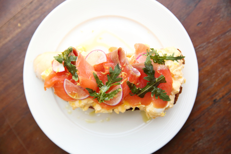 Scrambled eggs with smoked salmon and whole wheat toastの写真素材