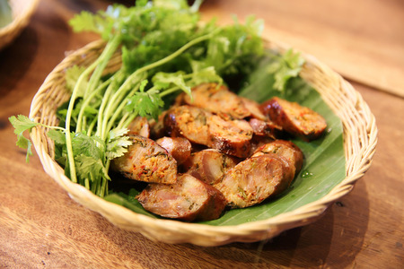 Artificial sausage in wood backgroundの写真素材