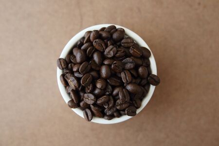Coffee beans isolated in wood backgroundの写真素材