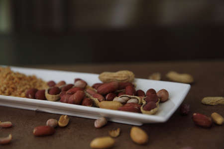 Peanuts in shells on wood background