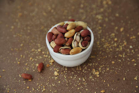 Peanuts in shells on wood background