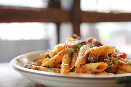 Penne pasta in tomato sauce with meatballsの写真素材