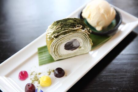 green tea roll cake with ice creamの写真素材
