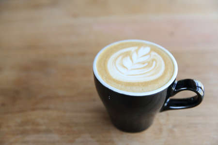 hot cappuccino coffee on wood background