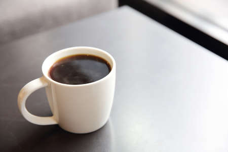 Black coffee on wood background in coffee shopの写真素材