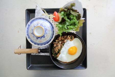 Stir fried pork and basil served with rice and fried egg , Thai foodの写真素材