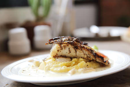 Grill sea bass fillets with crushed potatoes