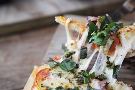 pizza with seafood and tomatoes on a wooden table , italian foodの写真素材
