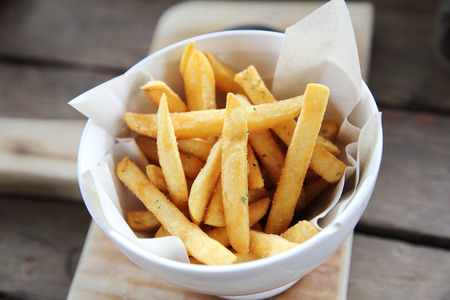 Fried potatoes french fries on wooden backgroundの写真素材