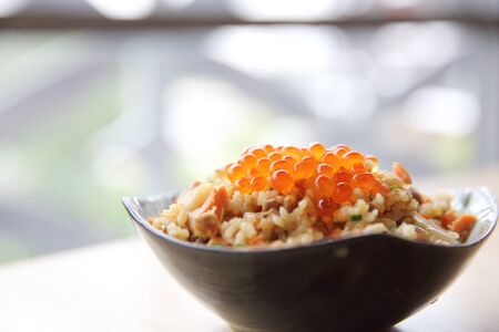 Japanese Cuisine Fried Rice with salmon and caviar on topの写真素材