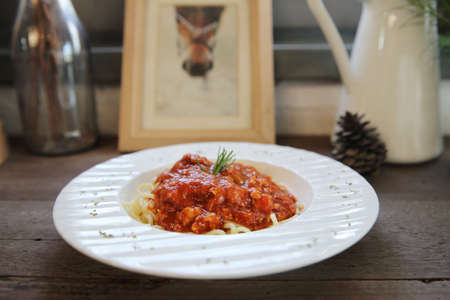 spaghetti bolognese on wood backgroundの写真素材