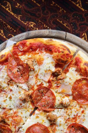 pepperoni pizza on wooden italian foodの写真素材
