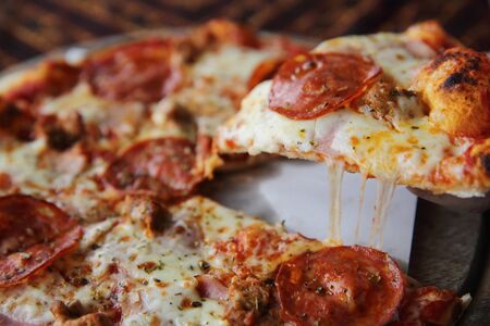 pepperoni pizza on wooden italian foodの写真素材