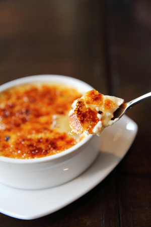 Creme Brulee on wood backgroundの写真素材