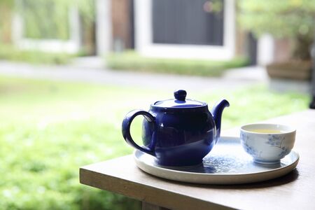 pouring tea into cup of tea in close up Chinese and Japan drinkの写真素材