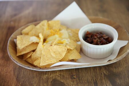 Cheese nachos with tomato sauceの写真素材