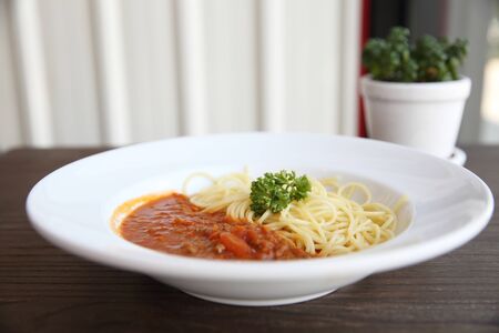 spaghetti bolognese in wood backgroundの写真素材