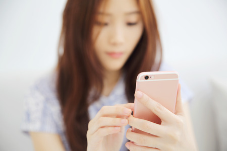 one Asian woman with smart phoneの写真素材