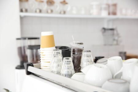 Coffee cups on Coffee machine in white coffeeshopの写真素材