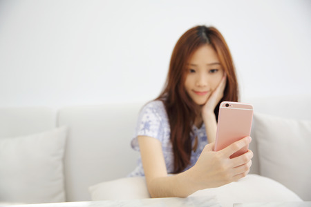 Young beautiful woman photo selfie in white toneの写真素材